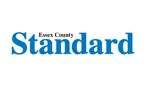 Logo with the words Essex County Standard. Essex County is in small black serif font, and Standard is in large blue serif font on a white background.