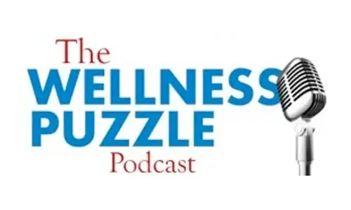 Logo for The Wellness Puzzle Podcast featuring the podcast name in bold blue and red text next to a classic silver microphone on a white background.