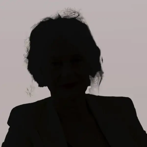 A silhouette of a person with wavy hair, wearing a jacket, is set against a light grey background—perfect for illustrating an Alcohol Recovery Mindset Coaching Case Study as the features and details are softened in shadow.
